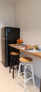 a kitchen with a counter with stools and a refrigerator at Adria in Opatija +34 photos