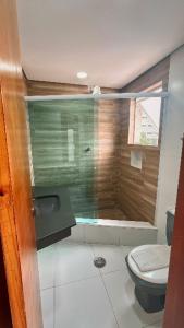 a bathroom with a toilet and a glass shower at Trade Hotel Diadema in Diadema +54 photos