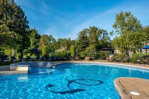 a swimming pool at a resort at Mont Gabriel, Sainte-Adèle, a Tribute Portfolio Resort in Sainte-Adèle