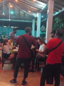 a group of people standing around a table playing music at Neue Villa Wunderschön in Bentota