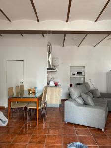 a living room with a couch and a table at ArroyoHome in Montoro