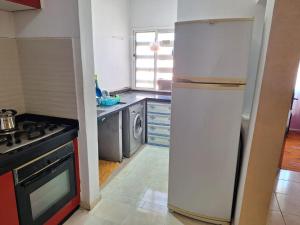 a kitchen with a refrigerator and a washing machine at Agadir fadissa in Agadir