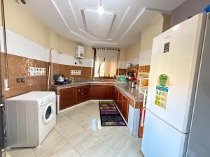 a kitchen with a refrigerator and a washer at Saidia appart in Saïdia