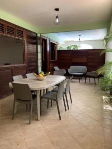 a dining room with a table and chairs at Bel appartement à Ducos avec piscine privée in Ducos