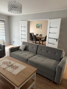 a living room with a couch and a table at Apartament 11 na 10 in Głuchołazy +21 photos