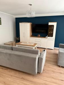 a living room with a couch and a table at Apartament 11 na 10 in Głuchołazy