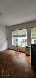 a living room with a wooden floor and a window at Hospedaje reconquista in La Porteña +6 photos