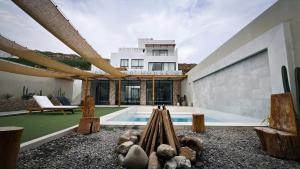 a villa with a swimming pool and a house at Diamond House in Simbal