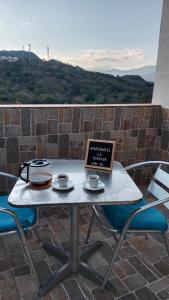 a table with cups and saucers on a patio at Apartahotel La Terraza - San Gil in San Gil