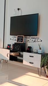 a entertainment center with a tv on top of it at Apartahotel La Terraza - San Gil in San Gil