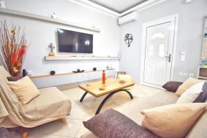 a living room with a couch and a table at Kosmas Family House Apartment 2 in Kanálion