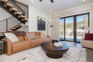 a living room with a couch and a table at Alpenglow Retreat in Winter Park