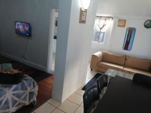 a living room with a couch and a table at 37 Grant prix lodge in Cape Town