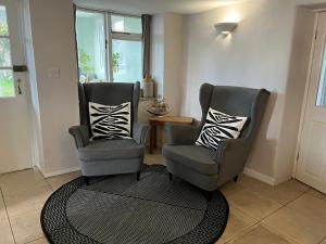 two chairs and a table in a living room at Fisherman's Cottage in Portland