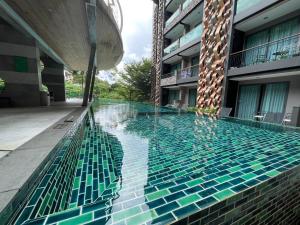 a swimming pool in the middle of a building at Emerald Terrace Condo 9-1 Bed City & Mountain in Patong Beach +8 photos