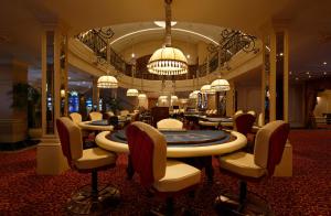 a salon with chairs and tables in a lobby at Beijing Hotel Minsk in Minsk