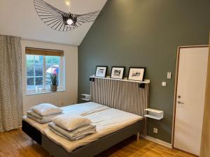 a bedroom with a bed with white sheets and pillows at Studio in Tygelsjö in Tygelsjö