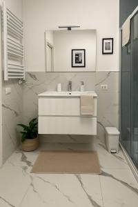 a white bathroom with a sink and a toilet at LB - Luna Luxury Suite in Bergamo +37 photos