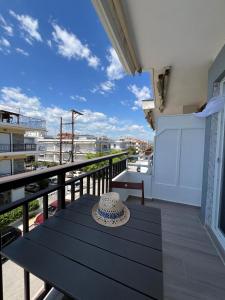 a hat sitting on a table on a balcony at Sunset Apartments in Paralia Dionysiou