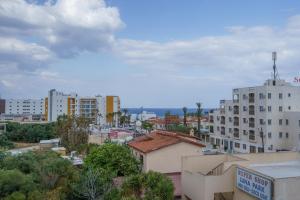 a view of a city with buildings and trees at Pernera One Suites in Pernera Protaras in Paralimni