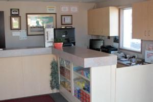 a kitchen with a counter with a refrigerator at Kingsway Inn in Thunder Bay