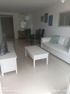 a living room with a couch and a table at Look Brava in Punta del Este