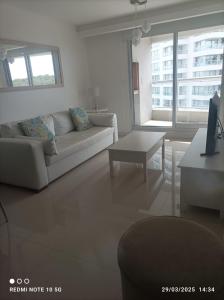 a living room with a couch and a table at Look Brava in Punta del Este