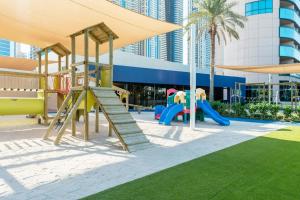 a playground in front of a building with a slide at The Westin Dubai Mina Seyahi Beach Resort and Waterpark in Dubai
