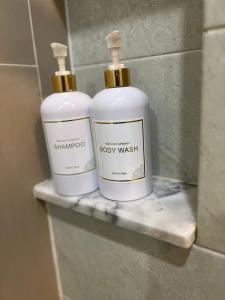 two bottles of shampoo sitting on a shelf in a bathroom at Emerald Terrace Condo 3-Studio Garden Gem in Patong Beach