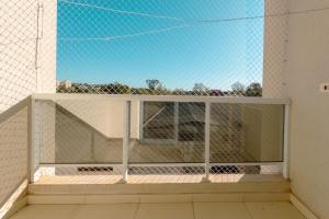 a view from the outside of a balcony with a window at Acolhedor e Confortável LZ101 in Maringá