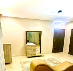 a living room with a dresser and a mirror at Mira alsafa in Jeddah +16 photos