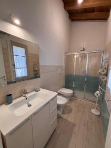 a bathroom with a sink and a toilet and a shower at BRES House in Porto Santo Stefano +23 photos