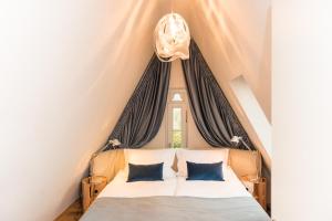 ein Schlafzimmer mit einem Bett mit zwei blauen Kissen in der Unterkunft Apartmenthaus am Dom mit Parkplatz in Zwickau