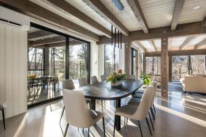 a dining room with a table and chairs at NEW! Lagom Tyst Chalet 7 Bedroom Hot Tub Near Resort in Mont-Tremblant