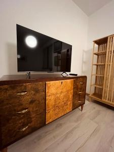 a large wooden dresser with a television on top of it at Your Italian Home in San Pietro in Cariano +7 photos