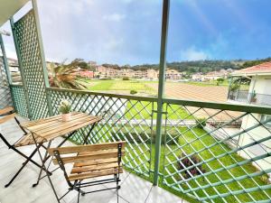 a balcony with a wooden table and a bench at Apartamento El Corrillo - 5835 in Isla