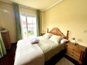 a bedroom with a large bed and a window at Apartamento El Corrillo - 5835 in Isla