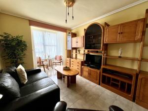 a living room with a couch and a table at Apartamento El Corrillo - 5835 in Isla