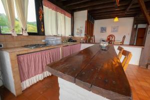 a kitchen with a wooden table in a room at Chalet junto al lago con muelle privado in Calima