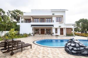 a villa with a swimming pool and a house at Sri Pool Villa - Jaffna in Jaffna