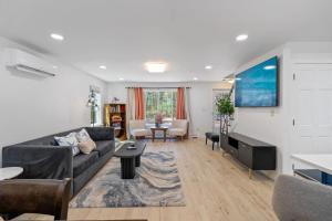a living room with a couch and a table at Breathtaking Riverfront Hideaway in Wareham in Wareham