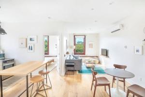 a kitchen and living room with a table and chairs at Annabelle 3B - New in Savannah