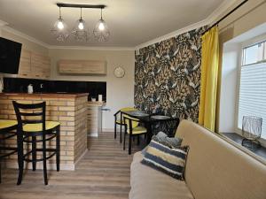a living room with a couch and a table at Domki u Magdy in Ustka
