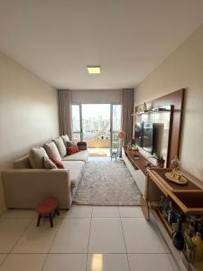 a living room with a couch and a television at Apartamento Belém COP30 in Belém