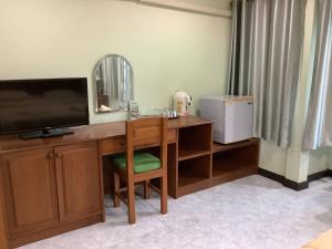 a room with a desk with a television and a mirror at Freedom house in Karon Beach +4 photos