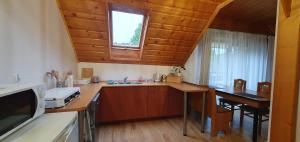 a kitchen with a sink and a table and a window at Pokoje "na Pierniku" in Szczawnica +7 photos
