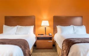 a hotel room with two beds and a table with a lamp at My Place Hotel-Hurricane, UT in Hurricane
