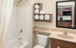 a bathroom with a toilet and a sink and a mirror at My Place Hotel-Hurricane, UT in Hurricane +10 photos