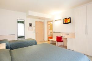 Säng eller sängar i ett rum på Hotel Miorelli