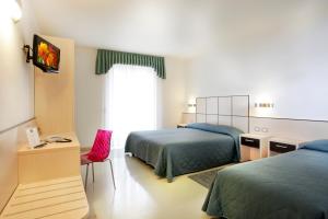 A bed or beds in a room at Hotel Miorelli